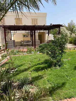 a wooden pergola in the yard of a house at Villa Sara Touristic Center in Hurghada