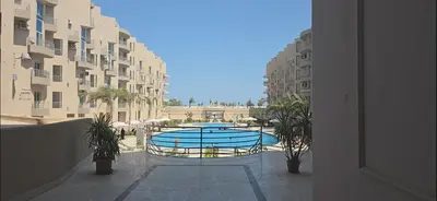 a view of a swimming pool in the middle of a building at princess apartments in Hurghada