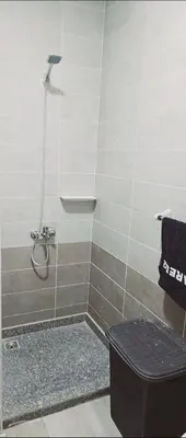 a bathroom with a shower with a bench in it at princess apartments in Hurghada