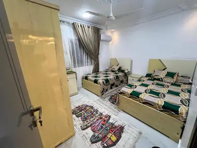 a bedroom with two beds and a door open at Excellent residential unit in Shellal