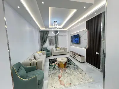 a living room with a couch and a table at Excellent residential unit in Shellal