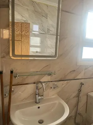 a bathroom with a sink and a mirror at Star house apartments in Hurghada