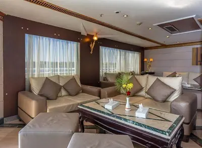 a living room with a couch and a table at Nile Cruise 3 Nights Aswan to Luxor Sightseeing Included in Nag` el-Ramla