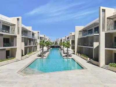 an image of a swimming pool in the middle of two apartment buildings at Doubletree By Hilton Mangroovy El Gouna Resort in Hurghada