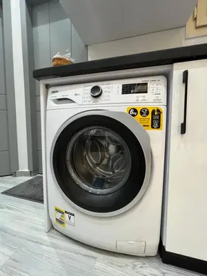 a white washing machine sitting next to a counter at BS Lodging 8- Next to Dream Beach in Hurghada