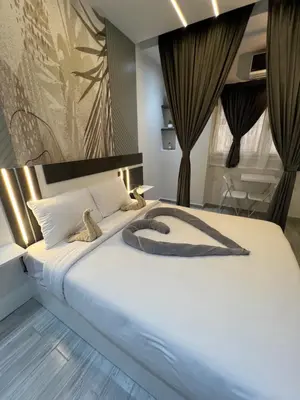 a bedroom with a large bed with two teddy bears on it at BS Lodging 8- Next to Dream Beach in Hurghada