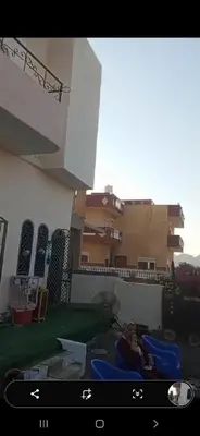 a woman is sitting on a blue chair in a building at Mo Asha in Safaga