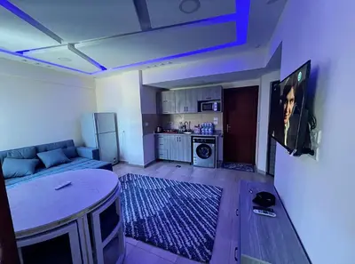 a living room with a couch and a kitchen at Princess Resort Hurghada in Hurghada