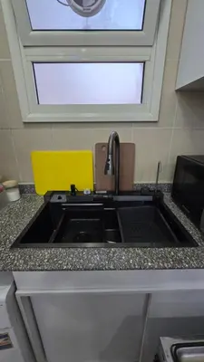 a kitchen counter with a sink and a window at Chalet private beach and pool view in Hurghada