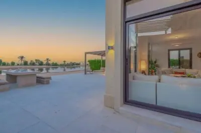 a large glass window of a building with a patio at The Lakefront Villa 4BR at Cyan ElGouna in Hurghada