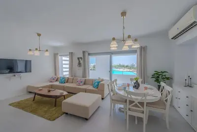 a living room with a couch and a table at Elegant 3BR on Swan Lake Crystal Lagoon at Elgouna Families Only in Hurghada