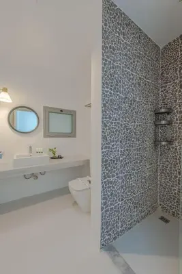 a bathroom with a toilet and a sink and a mirror at Elegant 3BR on Swan Lake Crystal Lagoon at Elgouna Families Only in Hurghada