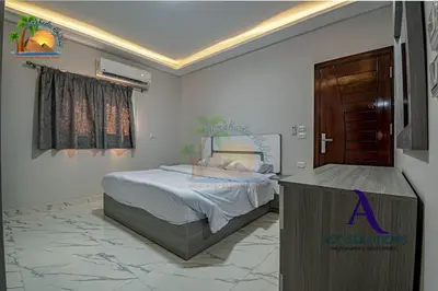 a bedroom with a bed and a tv in it at The Awesome 3-Bedroom Apartment & 2 bathroom in Al-Ahyaa Hurghada in Hurghada