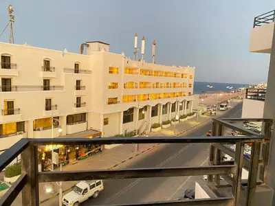 a building with a van parked in front of a street at استديو فندقى على البحر كمبوند بريستيجا اول طلعة فلفله الشيراتون in Hurghada
