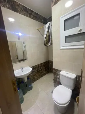 a bathroom with a toilet and a sink at استديو فندقى على البحر كمبوند بريستيجا اول طلعة فلفله الشيراتون in Hurghada