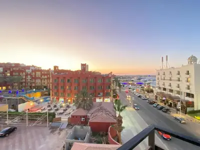 a view of a city street with cars and buildings at استديو فندقى على البحر كمبوند بريستيجا اول طلعة فلفله الشيراتون in Hurghada