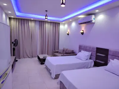 a hotel room with two beds and a couch at شاليه ب Selena Bay Resort in Hurghada