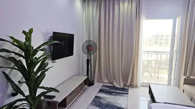 a living room with a fan and a plant at شاليه ب Selena Bay Resort in Hurghada