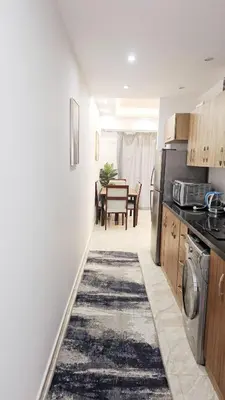 a kitchen with a table and a dining room at Selena Bay Resort Chalet in Hurghada