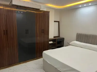 a bedroom with a bed and a large closet at Hurghada Hub in Hurghada