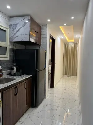a kitchen with a sink and a refrigerator at Hurghada Hub in Hurghada