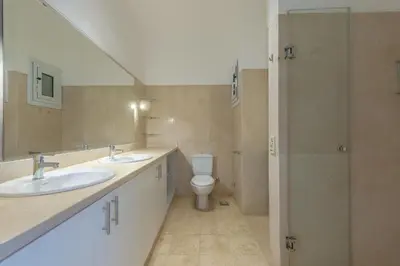 a bathroom with two sinks and a toilet at Cozy apartment with a pool in South Marina-Elgouna in Hurghada