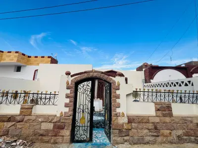a gate to a house with a blue sky at private home lucky seven in Luxor