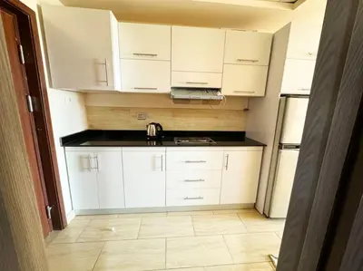 a kitchen with white cabinets and a sink at Hula Hula piece of the sea in Hurghada