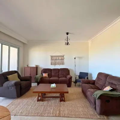 a living room with couches and a coffee table at Somabay Breezy Elegance 3BR Apartment in Hurghada