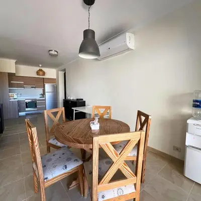 a kitchen and dining room with a table and chairs at Somabay Breezy Elegance 3BR Apartment in Hurghada