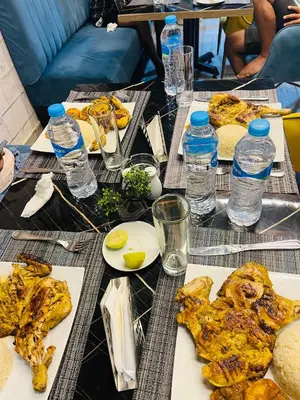 a table with plates of food and bottles of water at Juliana Beach Aqua park in Hurghada