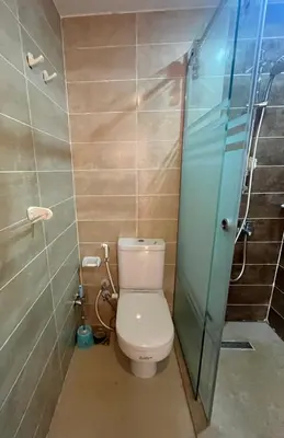 a bathroom with a toilet and a glass shower at Two Bedroom Apartment in Lilly Land in Hurghada