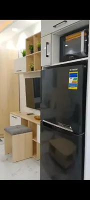 a kitchen with a black refrigerator and a desk at Juliana beach in Hurghada