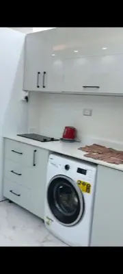 a washer and dryer in a white kitchen at Juliana beach in Hurghada