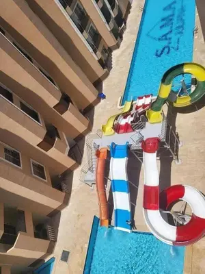 an overhead view of a pool with a water park at Juliana beach in Hurghada