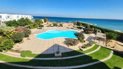an overhead view of a swimming pool and the ocean at Studil for rent old Sheraton 205 in Hurghada