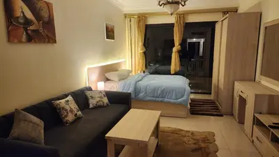 a living room with a couch and a bed at Studil for rent old Sheraton 205 in Hurghada