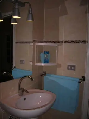 a bathroom with a sink and a mirror at Desert Rose Apartment in Hurghada