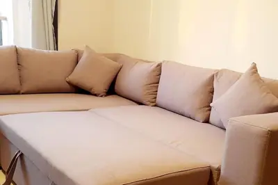 a white couch with pillows in a living room at Jomana Aldau Heights Hurghada rent one bedroom apartment in Hurghada