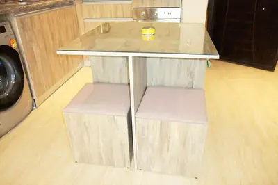 a table with two chairs and a cup on top of it at Jomana Aldau Heights Hurghada rent one bedroom apartment in Hurghada