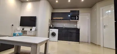 a kitchen with a washer and dryer in a room at Cozy 1BR in Princess Resort with Pools & Private Beach in Hurghada