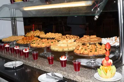 a buffet with many different types of cakes and pies at Mirage Bay Mina Land Resort & Aquapark in Hurghada