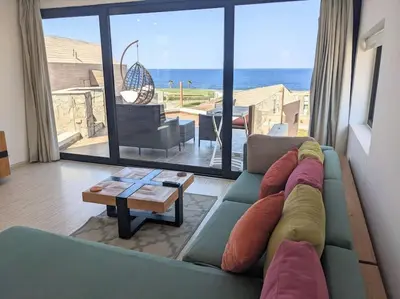 a living room with a couch and a view of the ocean at Elevated Sea View 2BR Standalone Free Beach & Pool in Somabay in Hurghada