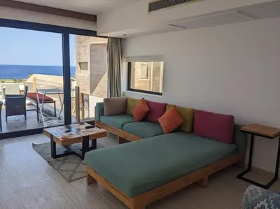 a living room with a couch and a table at Elevated Sea View 2BR Standalone Free Beach & Pool in Somabay in Hurghada
