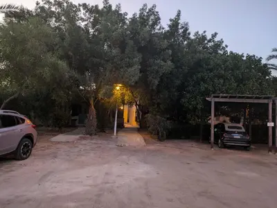 a car parked in front of a house with trees at Studio Serenity Downtown El Gouna in Hurghada