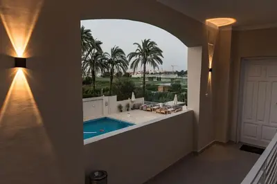 a hallway with a view of a swimming pool in a house at Royal Nile Suites - Luxury Nile View 1 in Al Aqālitah