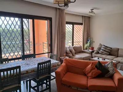 a living room with a couch and a table at Family Fun -Spacious Apartment in Hurghada