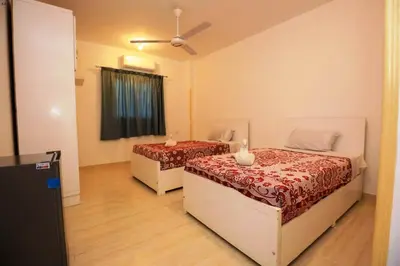 a bedroom with two beds and a ceiling fan at Luxor View Hotel in Luxor