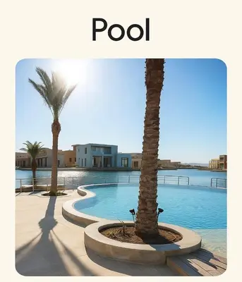 a swimming pool with two palm trees and the words pool at lagoon villa in Hurghada