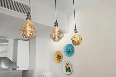 four lights hanging from a wall in a kitchen at Luxurious private Getaway in Mangroovy in Hurghada